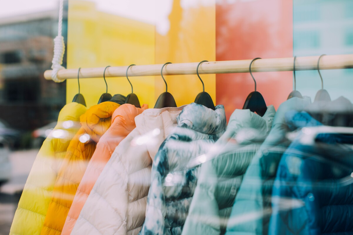 Jackets in various colors at display in front of a shop